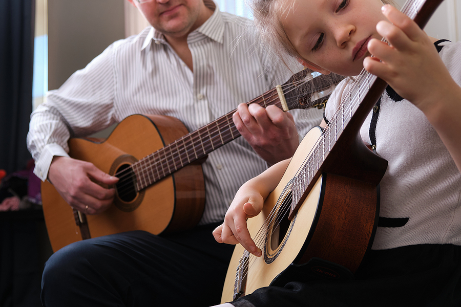 Little Girl And Her Father Are Playing Guitar. Learning To Play | Genazzano